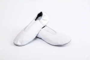 leather gymnastic shoes with suede or rubber grip sole in white, black, pink, and sky blue