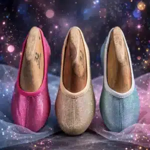 Three glitter gymnastic ballet slippers in hot pink gold and light blue on sparkling dance stage scenery with glitter bokeh lights - 600x900 product only banner no models